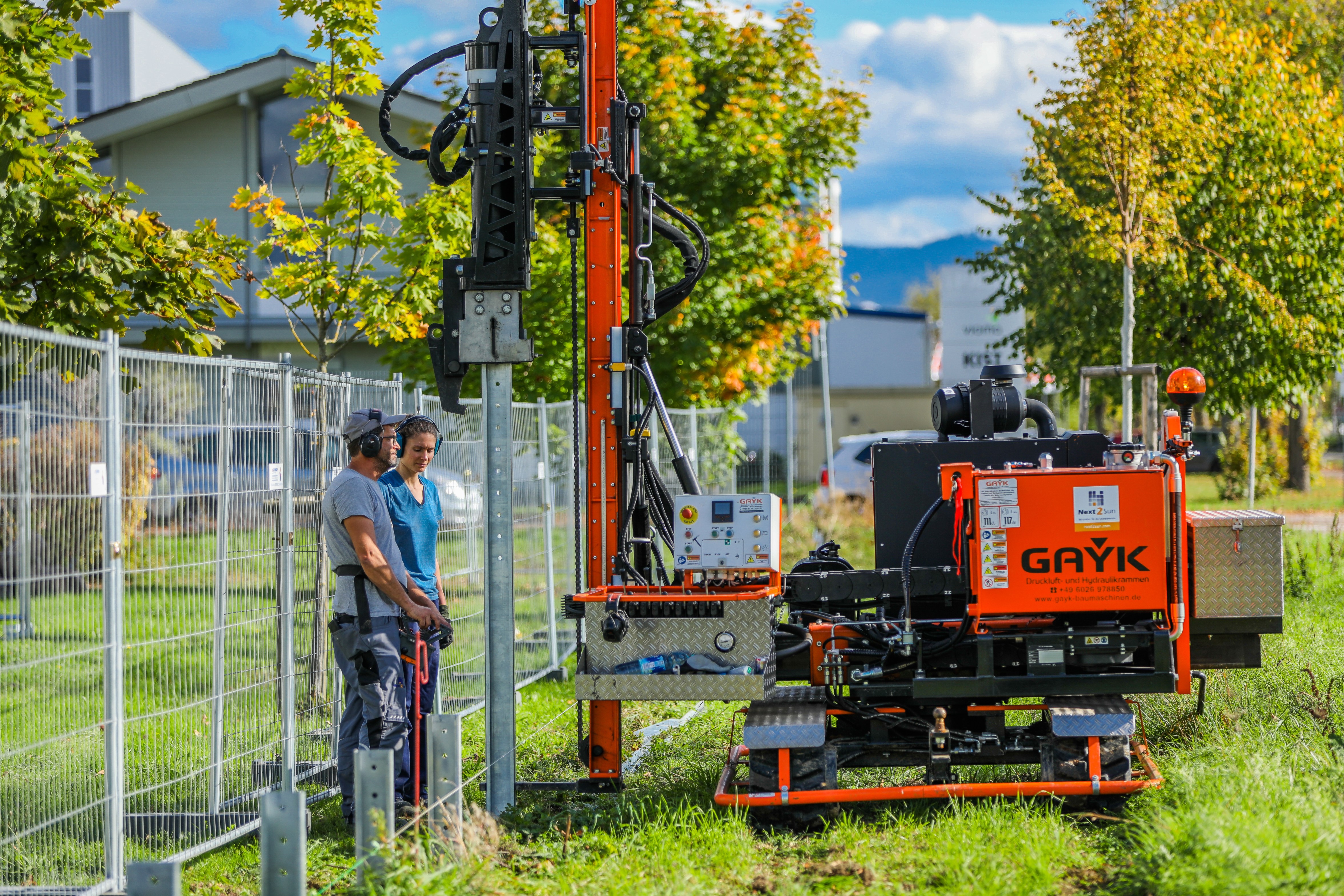 a couple of people standing next to a train