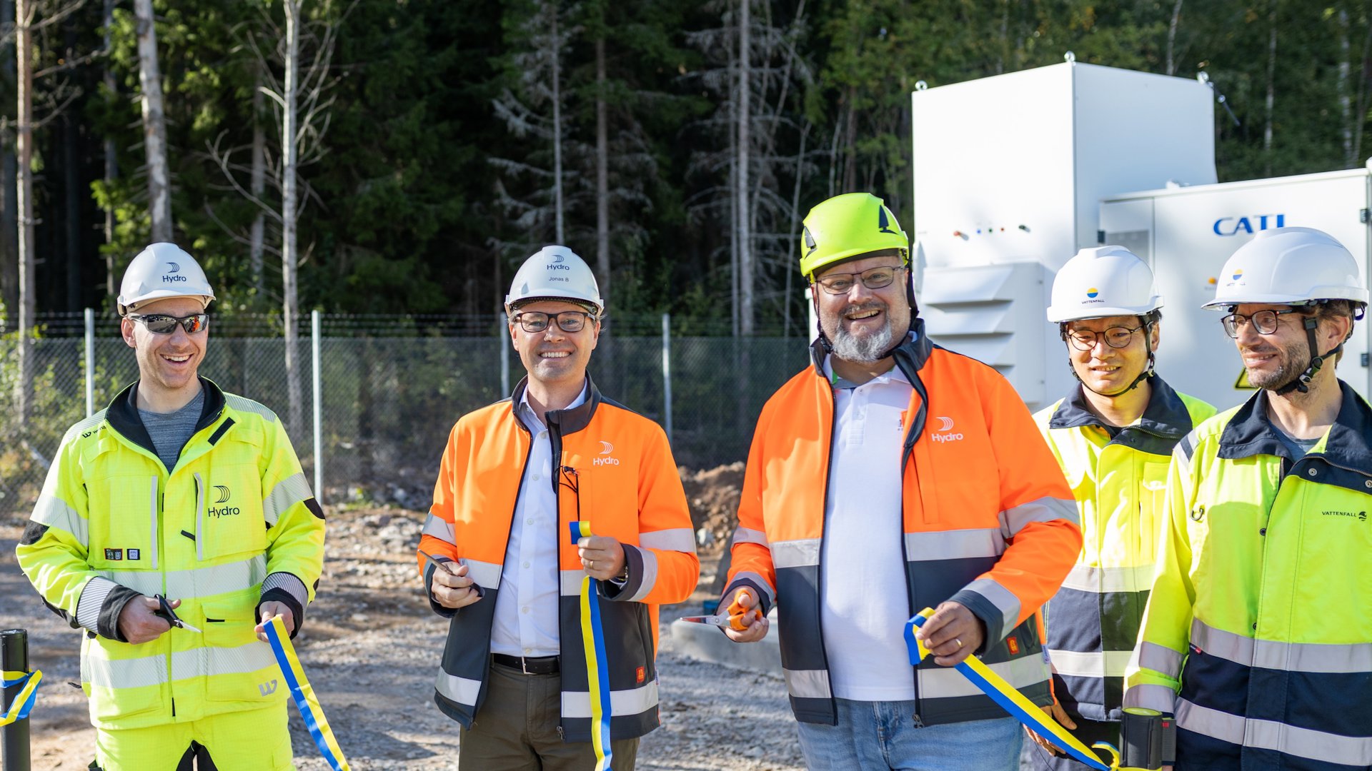 a group of men wearing safety vests and standing outside a group of men wearing safety vests and standing outside