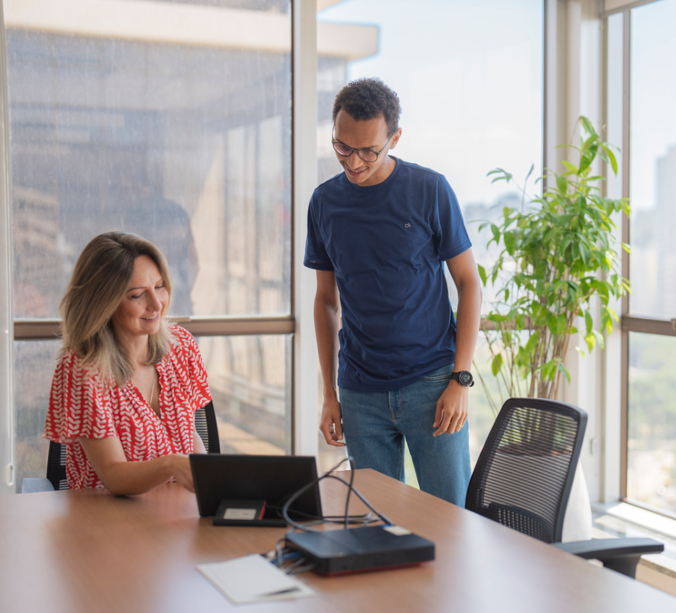 a man and a woman standing in front of a window